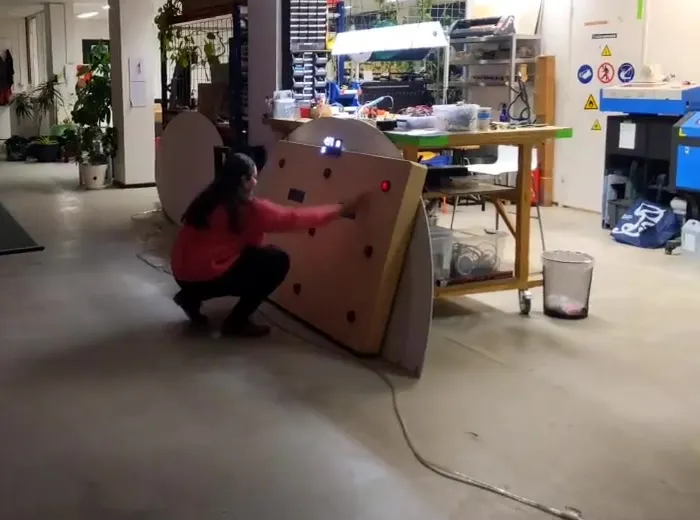 Reaching for a lit red target on the panel